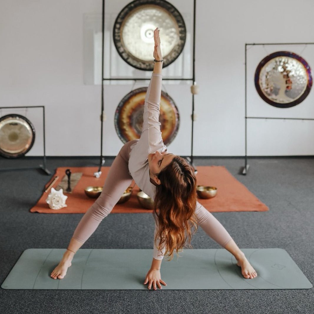 Professional yoga instructor leading a corporate yoga session in Timișoara, focusing on stress relief and workplace well-being.